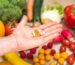 Hand,Is,Holding,Food,Supplement,Tabletts,Over,A,Wooden,Table